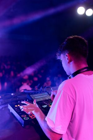 A DJ mixing on stage using board