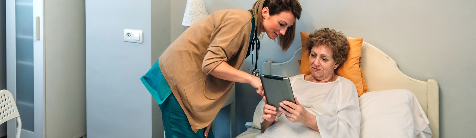 Female doctor showing results of a medical test on the tablet