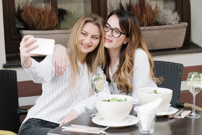 Young women taking selfie in restaurant