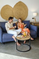 Delighted couple chilling on sofa in living room together
