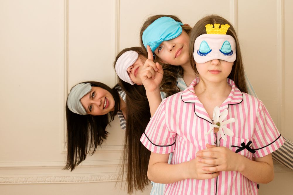 Girls peeking from behind another girl