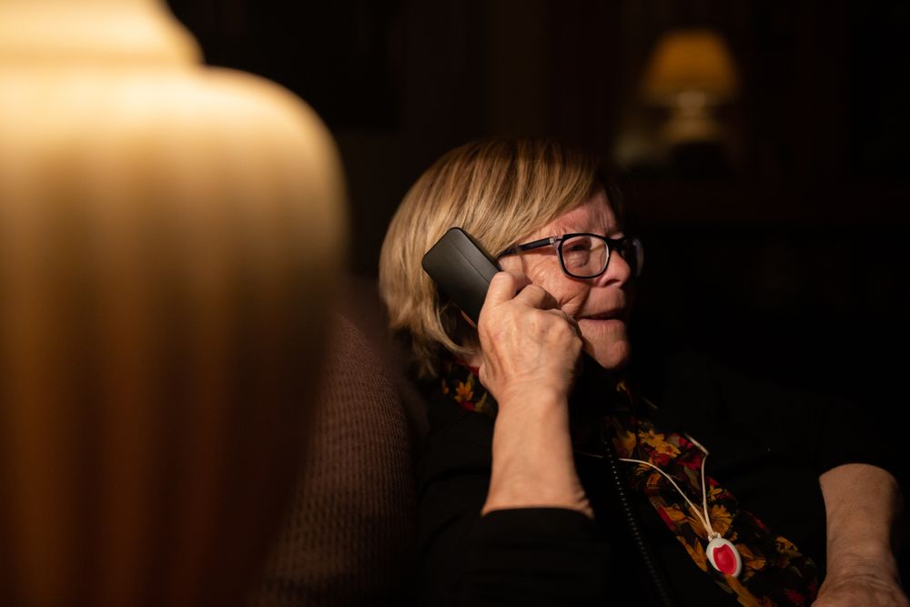 Pleased mature female talking on phone