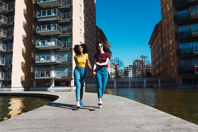 Two woman  friends strolling in town