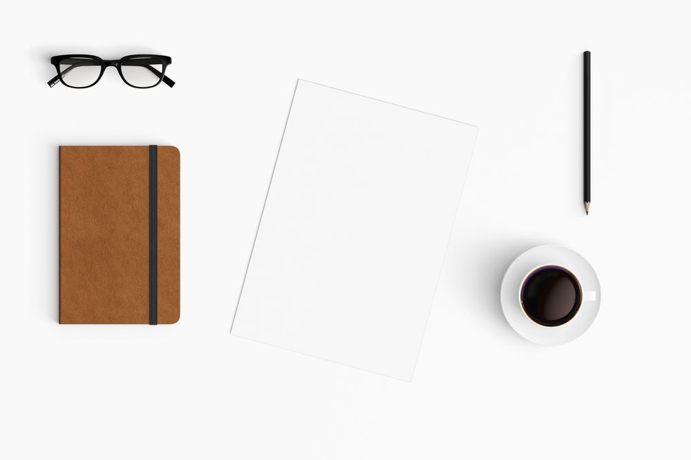 Modern workspace with coffee cup, smartphone, paper, tablet and notebook copy space