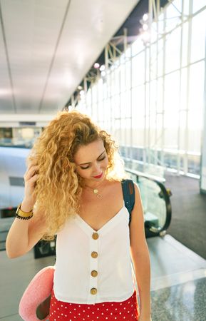 woman walking in spacious hall in sunlight