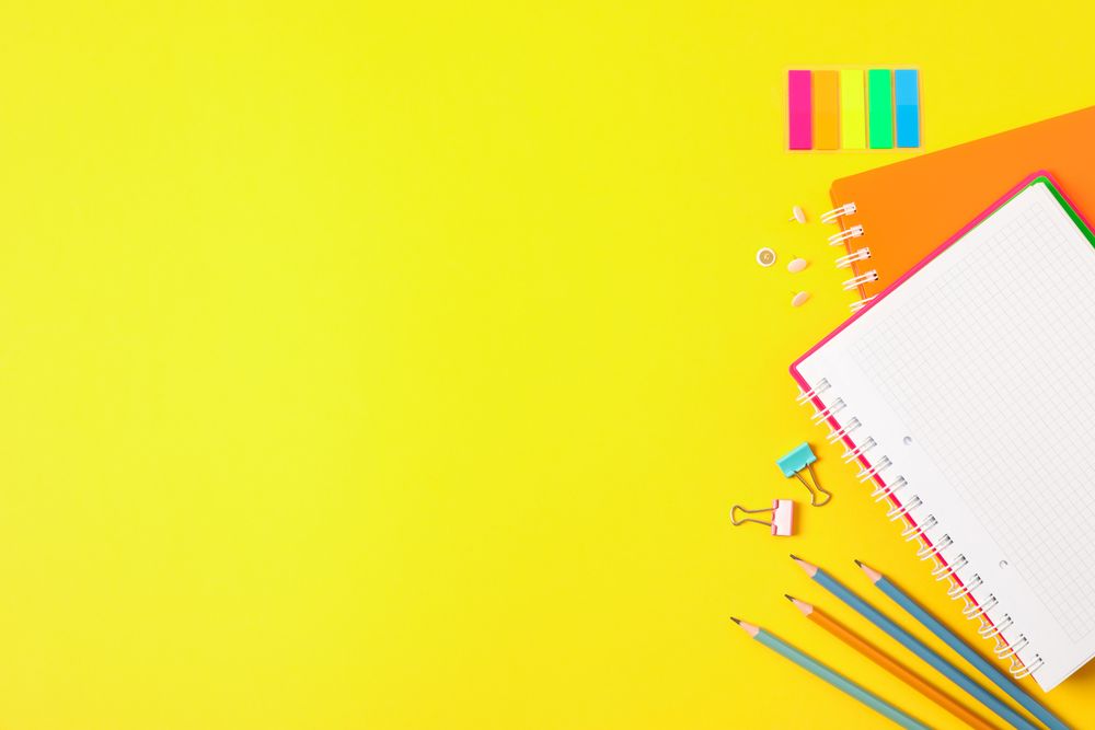 Flat lay composition with school supplies on color background, space for text