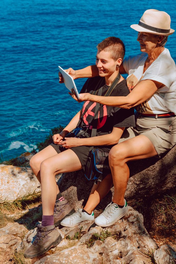 Older woman with tablet in hands taking selfie