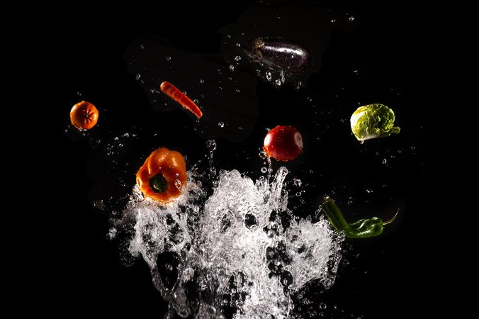 Flying fresh vegetables in splashes of water