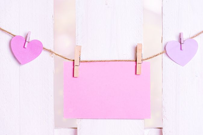 Message card and pink hearts on a string