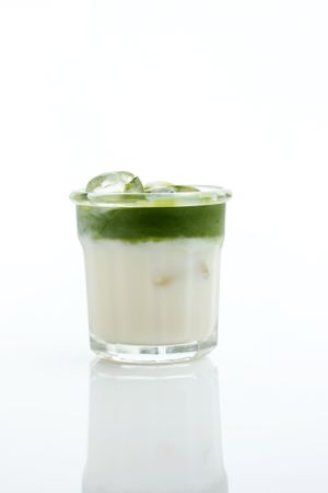 Glass of Tasty Matcha Latte isolated on Studio Background