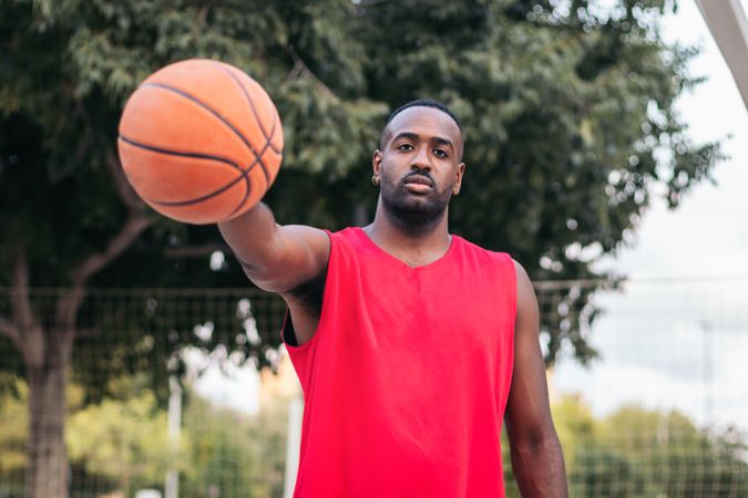 Confident Basketball Player Holding Ball with Determination