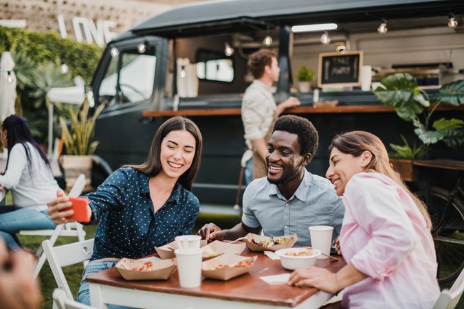 Multiracial people having fun doing selfie at food truck outdoor