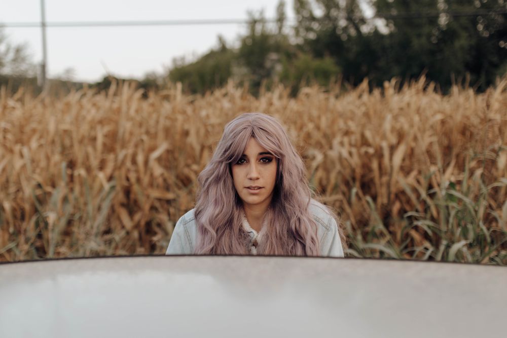 Woman with pink hair in countryside