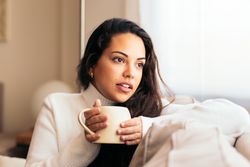 Enjoying Morning at Home: Young Woman Drinking Coffee