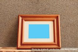 Rectangular wooden picture frame leaning against wall mockup 5X1zG4