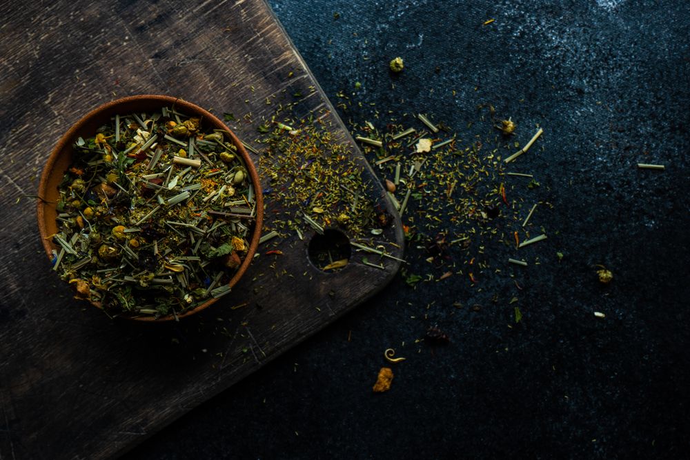 Bowl of green tea on wooden board