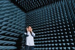 Woman in sound room listening to music