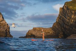 Woman on paddleboard floating in sea