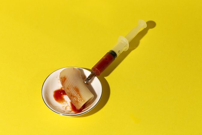 Stuffed pasta with red sauce in syringe