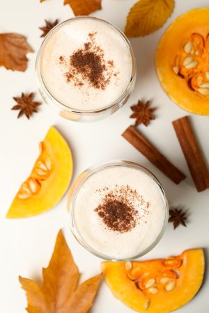 Composition with pumpkin latte on neutral background, top view