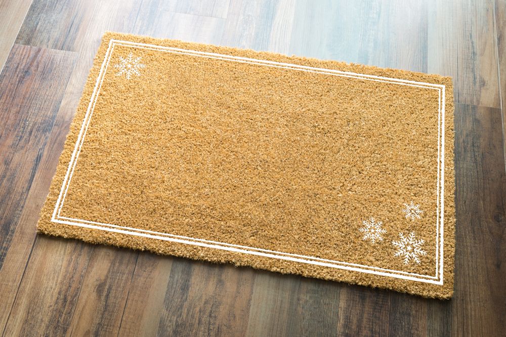 Blank Holiday Welcome Mat With Snow Flakes On Wood Floor Background