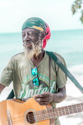 Jamaican man playing guitar