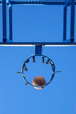 Street basketball ball falling into the hoop