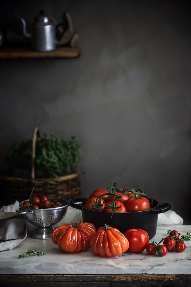 Ripe fresh tomatoes in pot on table