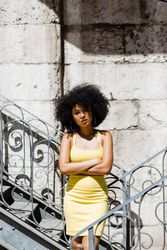 Stylish Black female leaning on railing outdoors