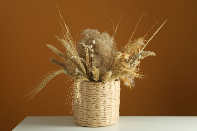 Beautiful dried floral arrangement in wicker basket