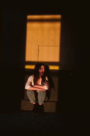 Smiling woman in spot of light