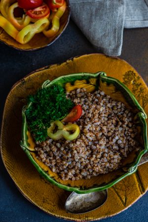 Bowl of buckwheat with tomatoes and mini peppers and tomatoes