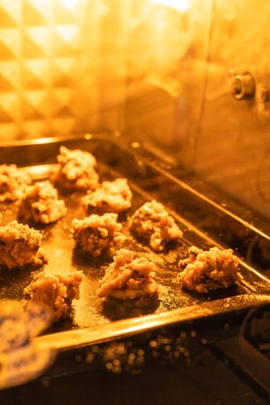 Chocolate chip cookies baking inside an oven