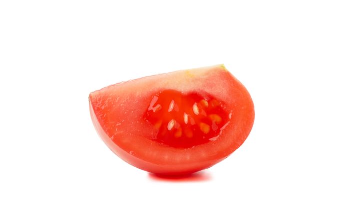 Fresh tomato slice isolated on neutral background