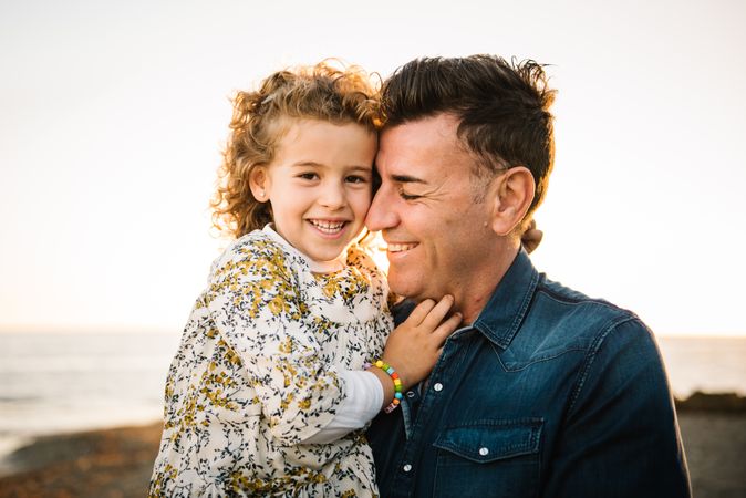 Father with her daughter at beach