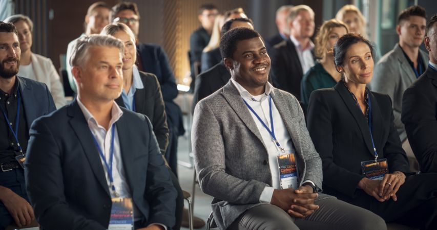Diverse Business People Sitting In Audience At International Technology Conference.