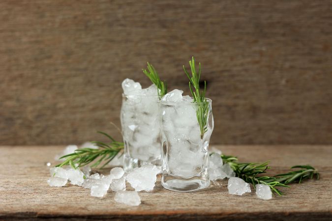 Glass full of ice with sprig of rosemary