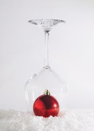 Holiday abstract concept of bauble in wine glass