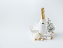 Champagne bottle and golden Christmas decoration on  background