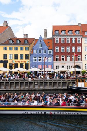 Tourist boat riding past riverfront in Copenhagen