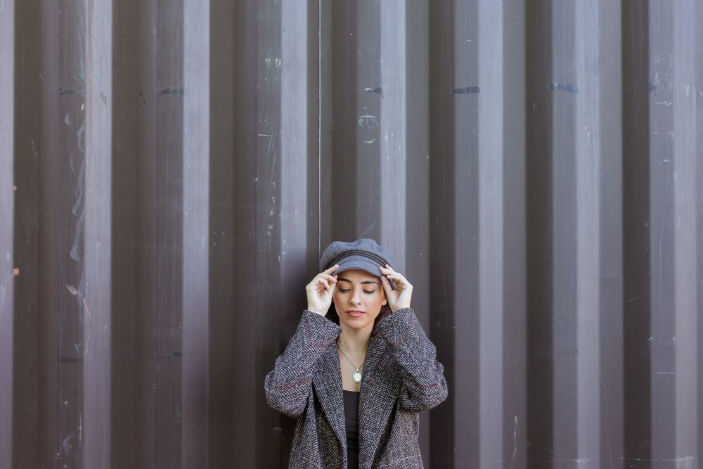 Charming Hispanic woman near wall