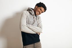 Man smiling with arms crossed