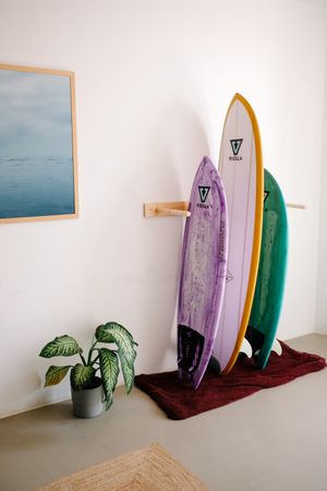 Colorful surfboards propped up in rack