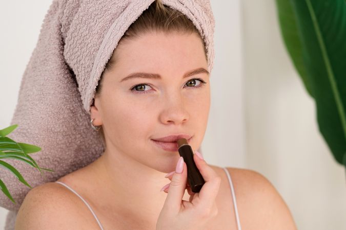 Close-up of woman applying lipstick