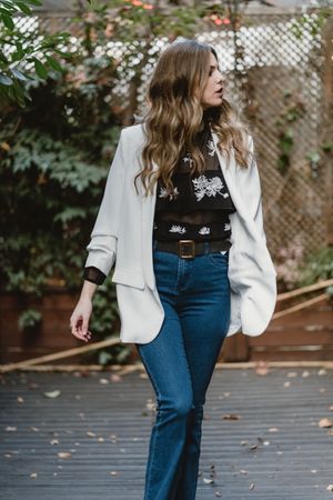 Woman standing on planter in garden