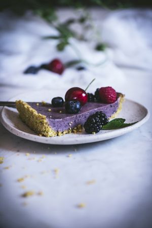 Blueberry pistachio sliced cake with whole berries on top
