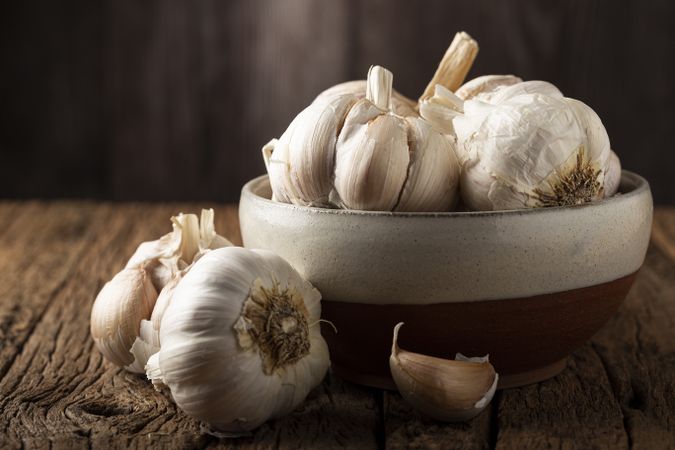 Garlic bulb and garlic cloves on the wooden table.