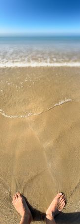 Panoramic view of feet in the sand at low tide, ile de Ré, France
