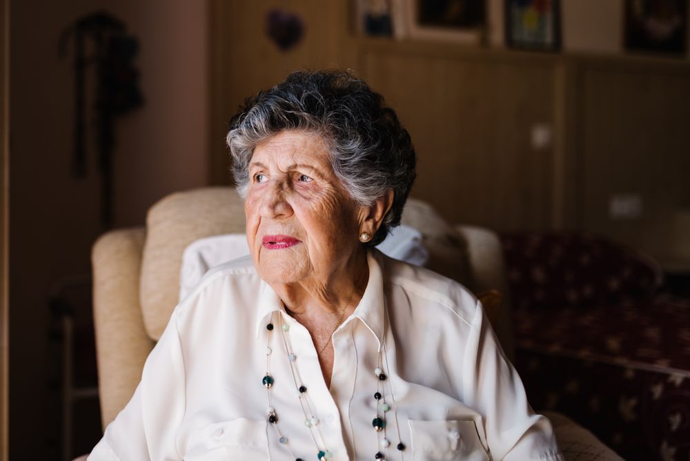 Portrait of older female in white shirt at home