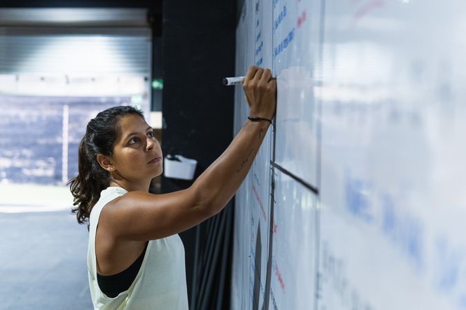 Sportswoman writing on board